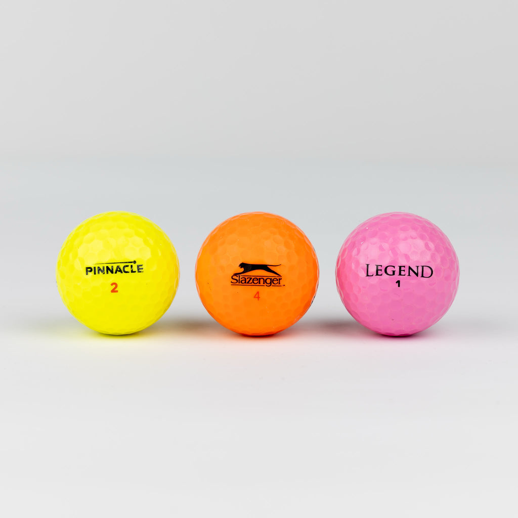 Gekleurde golfballen (roze, oranje, geel)