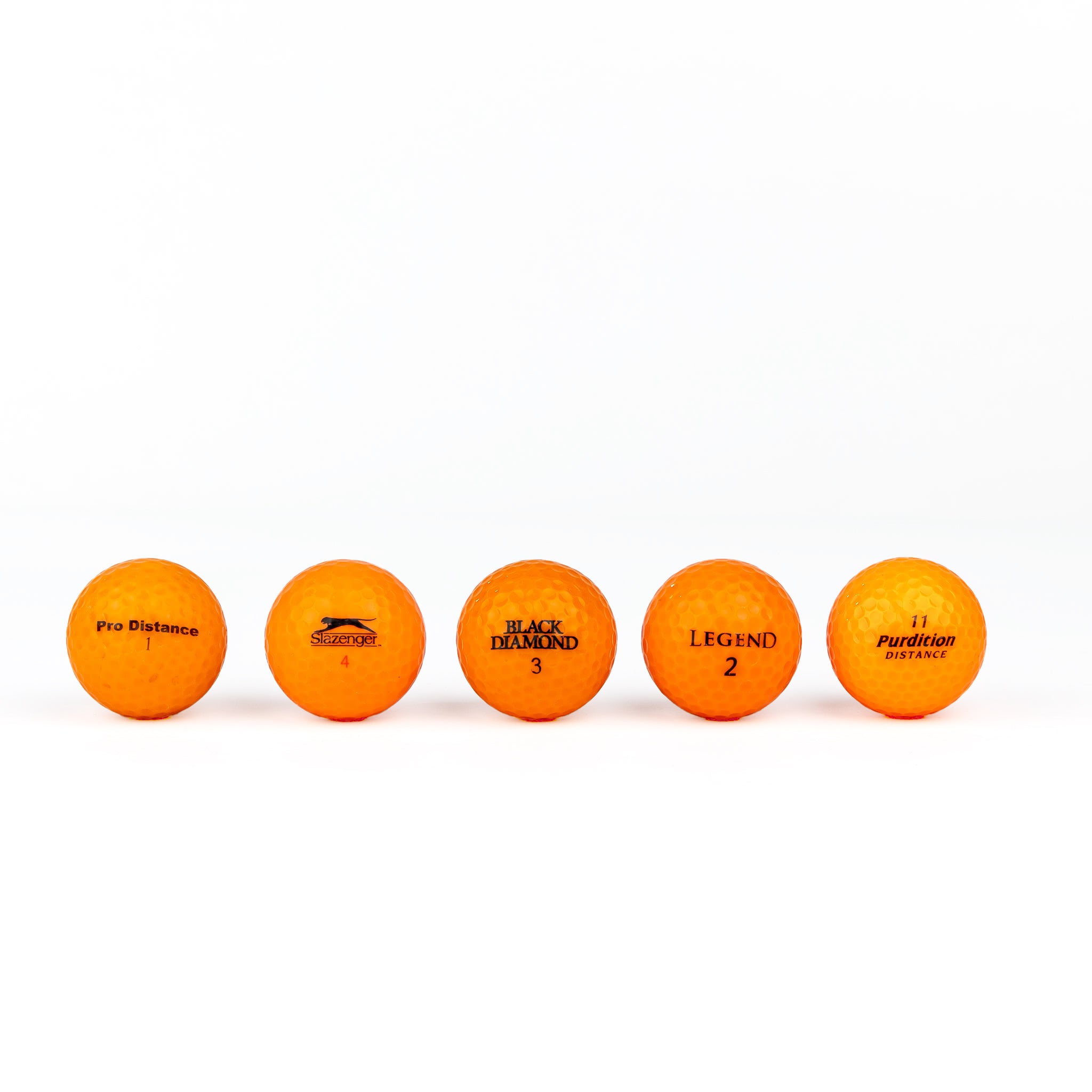 Gekleurde golfballen (roze, oranje, geel)