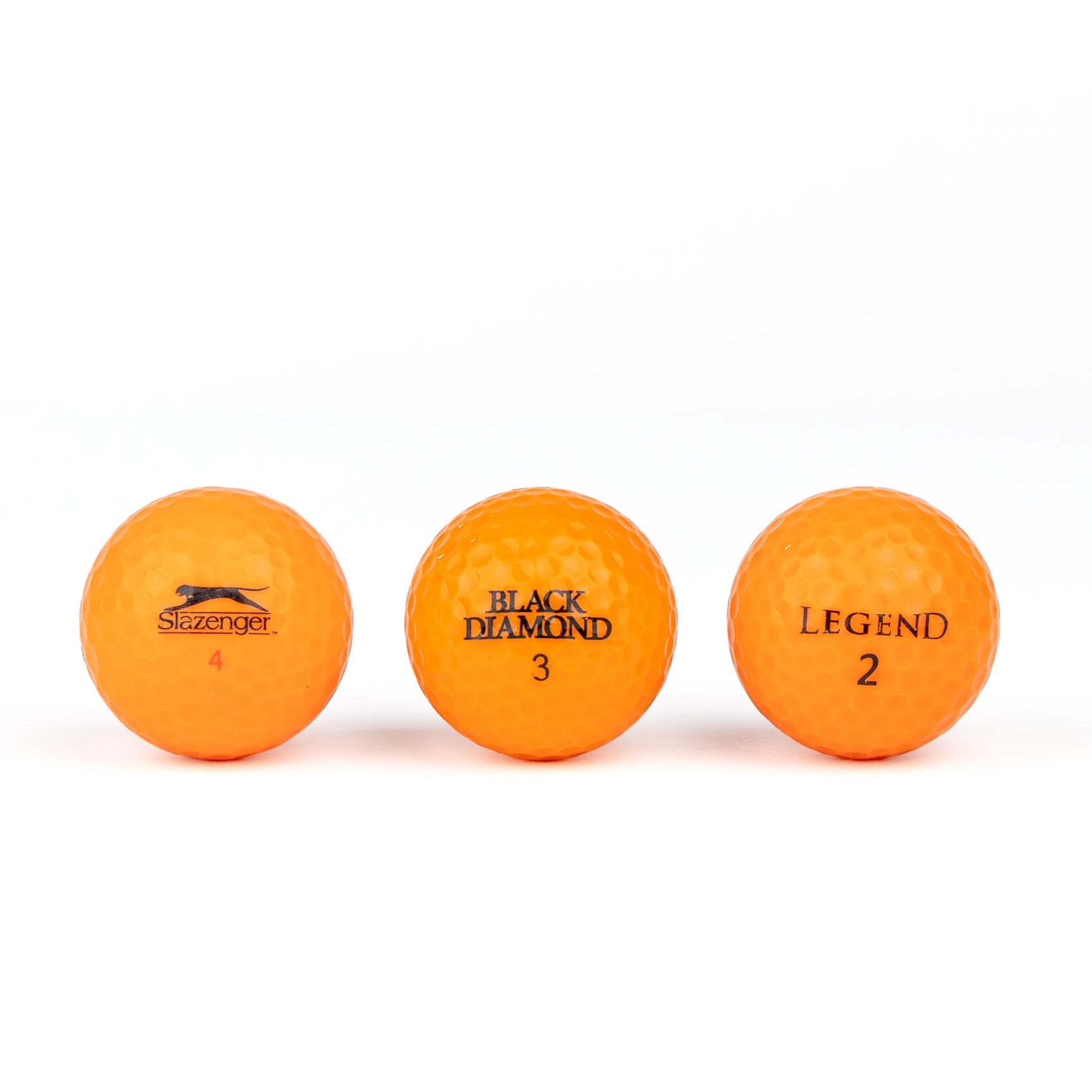 Gekleurde golfballen (roze, oranje, geel)